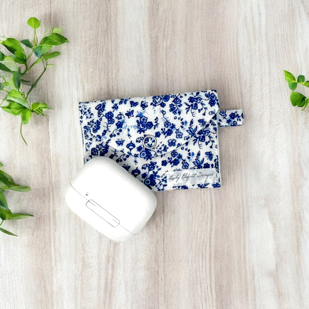 Handmade AirPods pouch with blue floral design, fabric AirPods case, elegant AirPods holder, soft protective pouch for AirPods, snap closure AirPods bag.