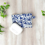 Load image into Gallery viewer, Handmade AirPods pouch with blue floral design, fabric AirPods case, elegant AirPods holder, soft protective pouch for AirPods, snap closure AirPods bag.
