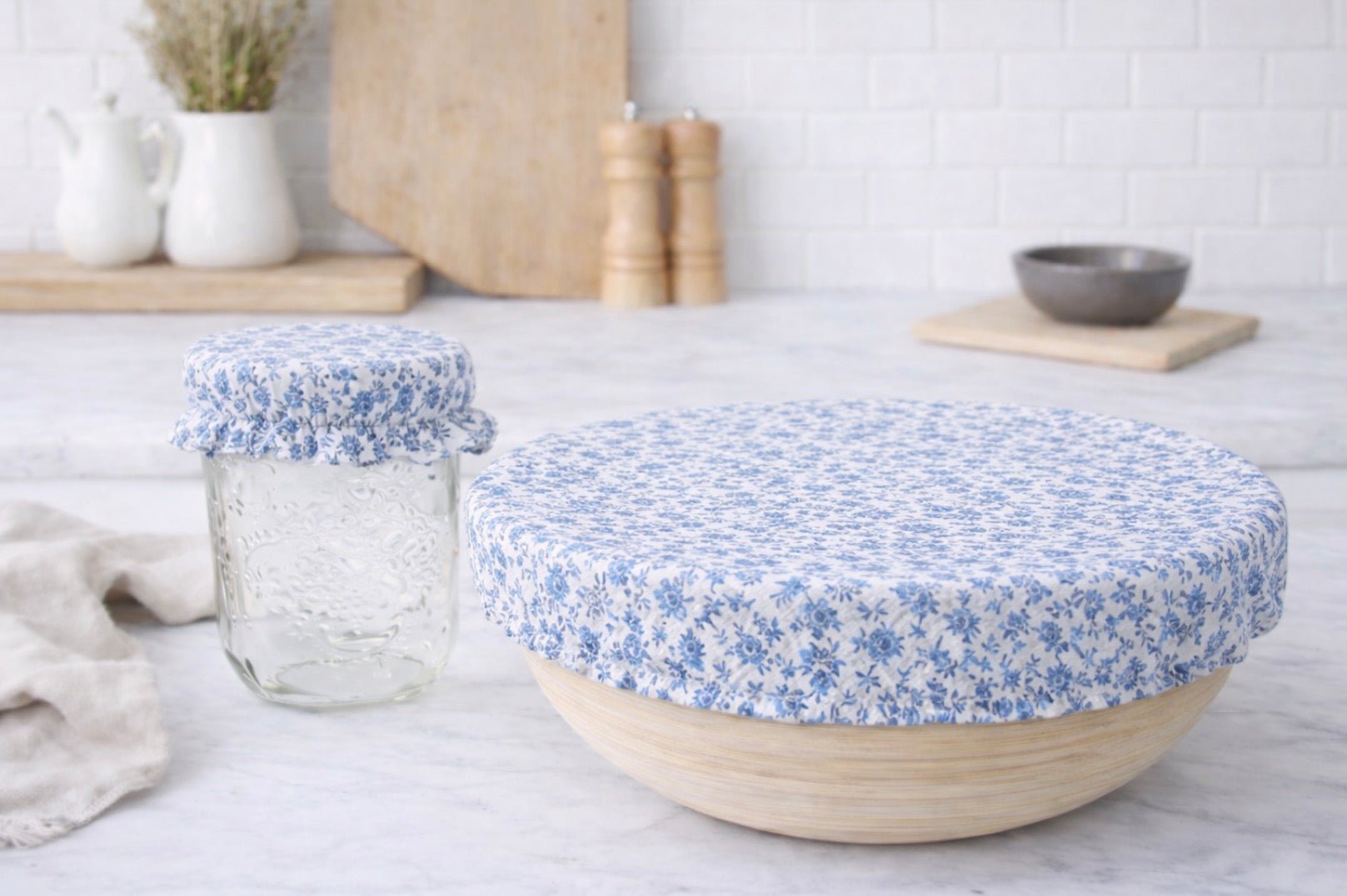 Blue floral reusable fabric bowl cover on bowl and jar, eco-friendly food storage cover for kitchen use