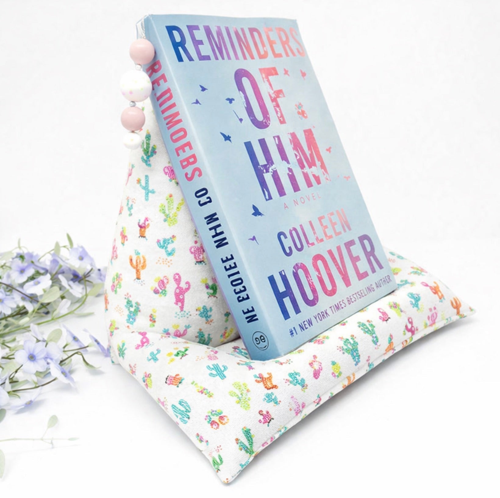 Cactus print book pillow stand supporting an open book for comfortable reading