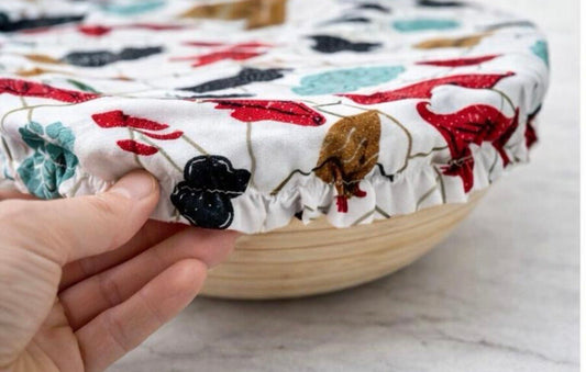 Close-up of a reusable fabric bowl cover showing elastic edge for a secure fit on a wooden bowl