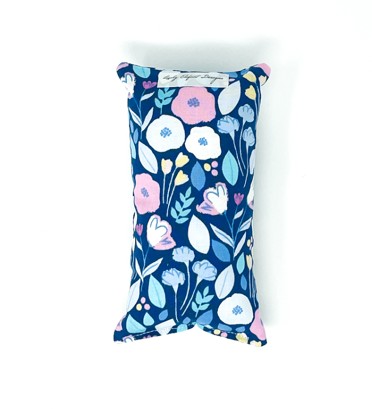 Blue floral chemo port pillow designed to protect chest port from pressure and irritation during daily use