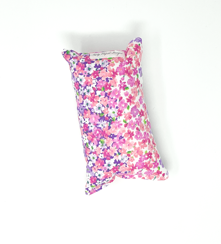 Pink and purple floral chemo port pillow designed to cushion chest port and reduce pressure during recovery and daily wear